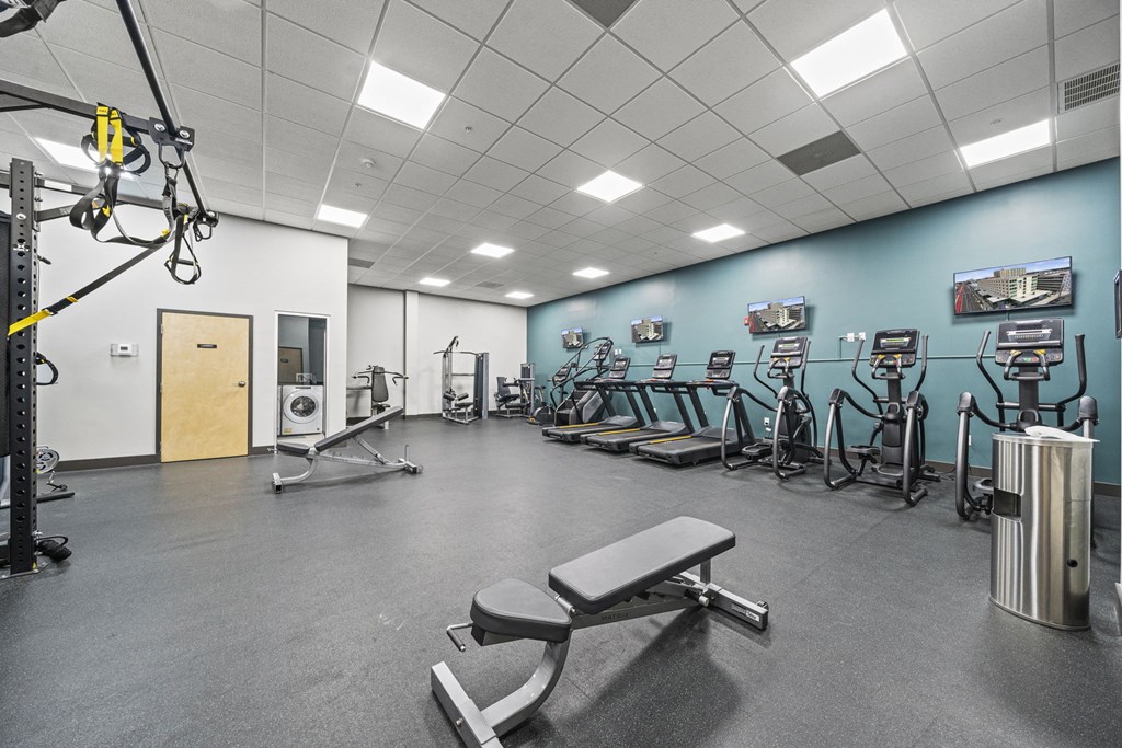 a large fitness room with cardio equipment and weights  at The Icon, Richmond, VA 23230