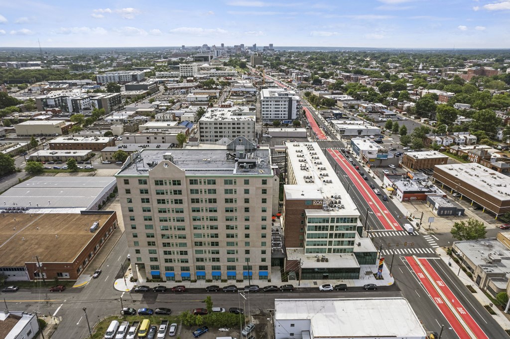 an aerial view of a city with a red train in the middle of the street at The Icon, Richmond, VA 23230