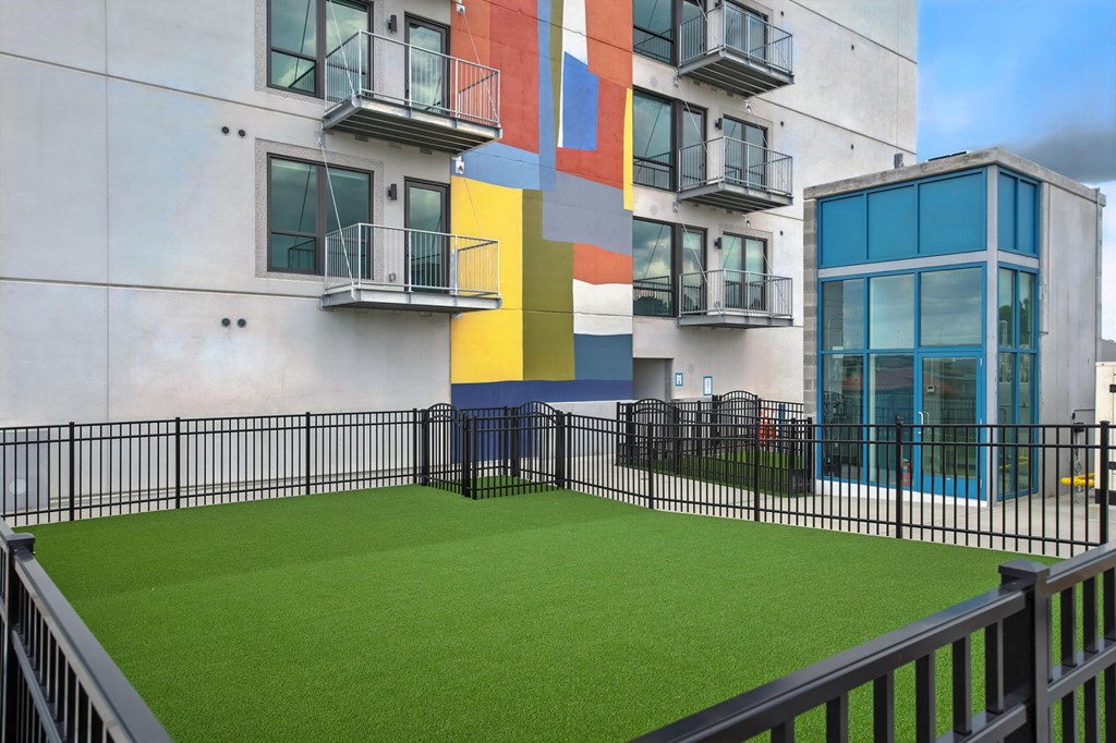 A building with a green lawn in front.