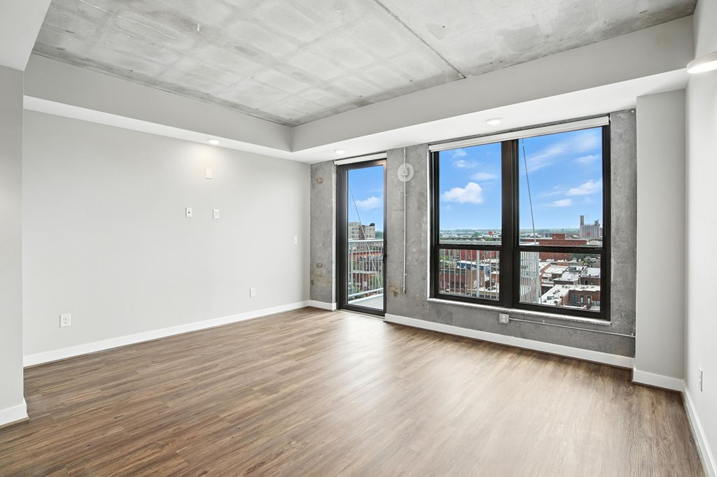 A room with a large window and a view of a cityscape.