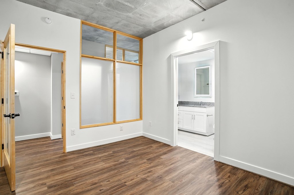 A room with a wooden floor and white walls.