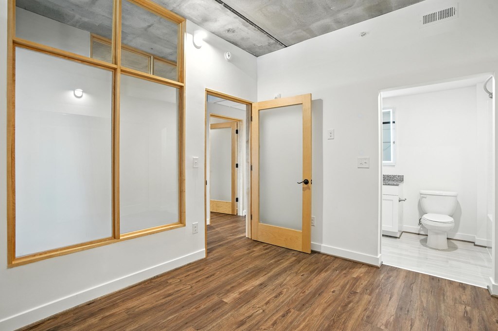 A room with a toilet and a door.