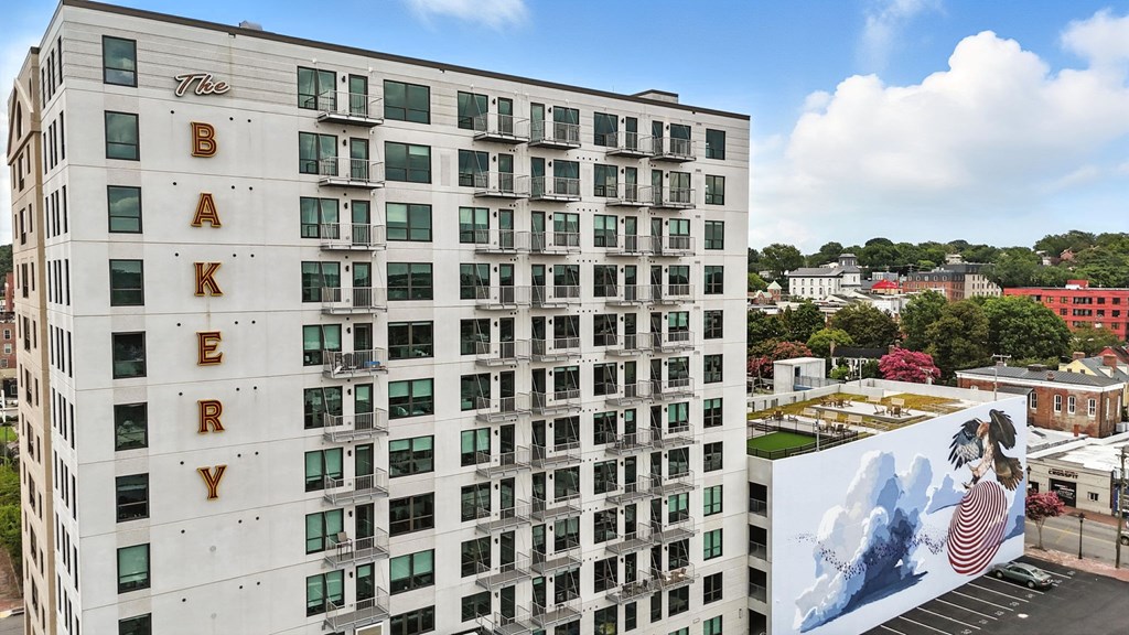 The Bakery building is a white, multi-story structure with a mural on the side.