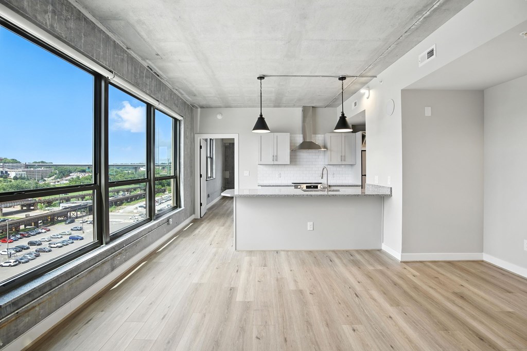 A kitchen area with a view of a parking lot.