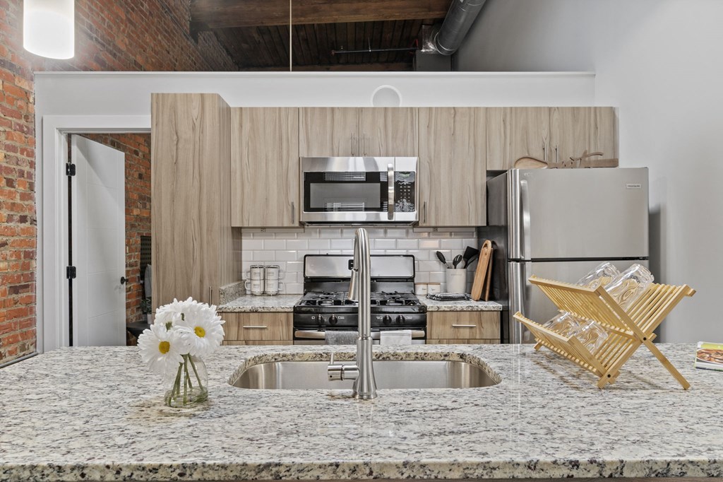 a kitchen with a large island with a sink and a stove