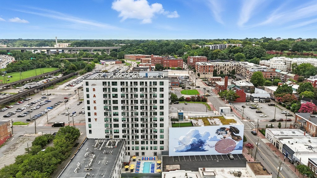 A large white building with a pool in the middle of a parking lot.