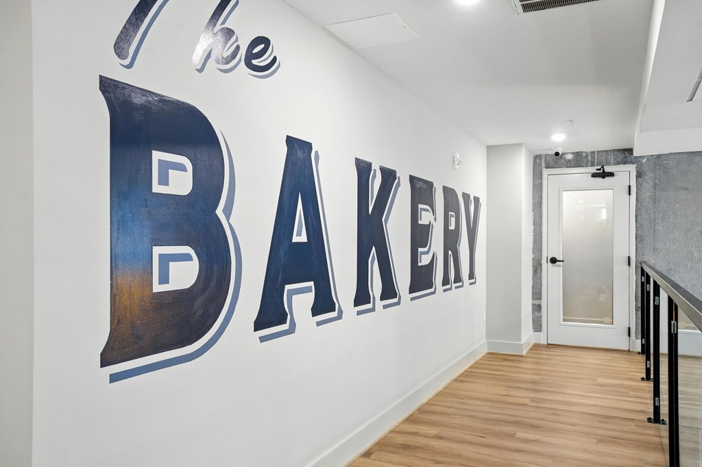 A wall with a large sign that says "The Bakery".