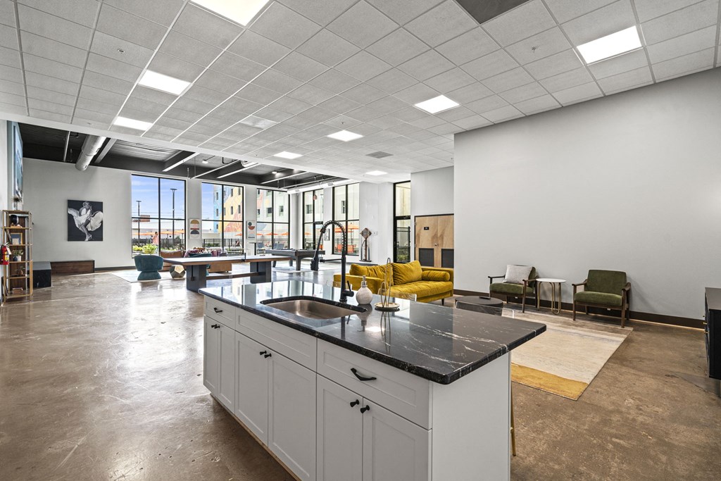 a large open space with a kitchen island and yellow couches  at The Icon, Richmond, VA 23230