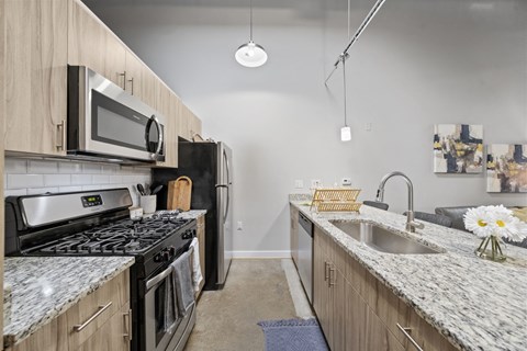 a modern kitchen with granite counter tops and stainless steel appliances