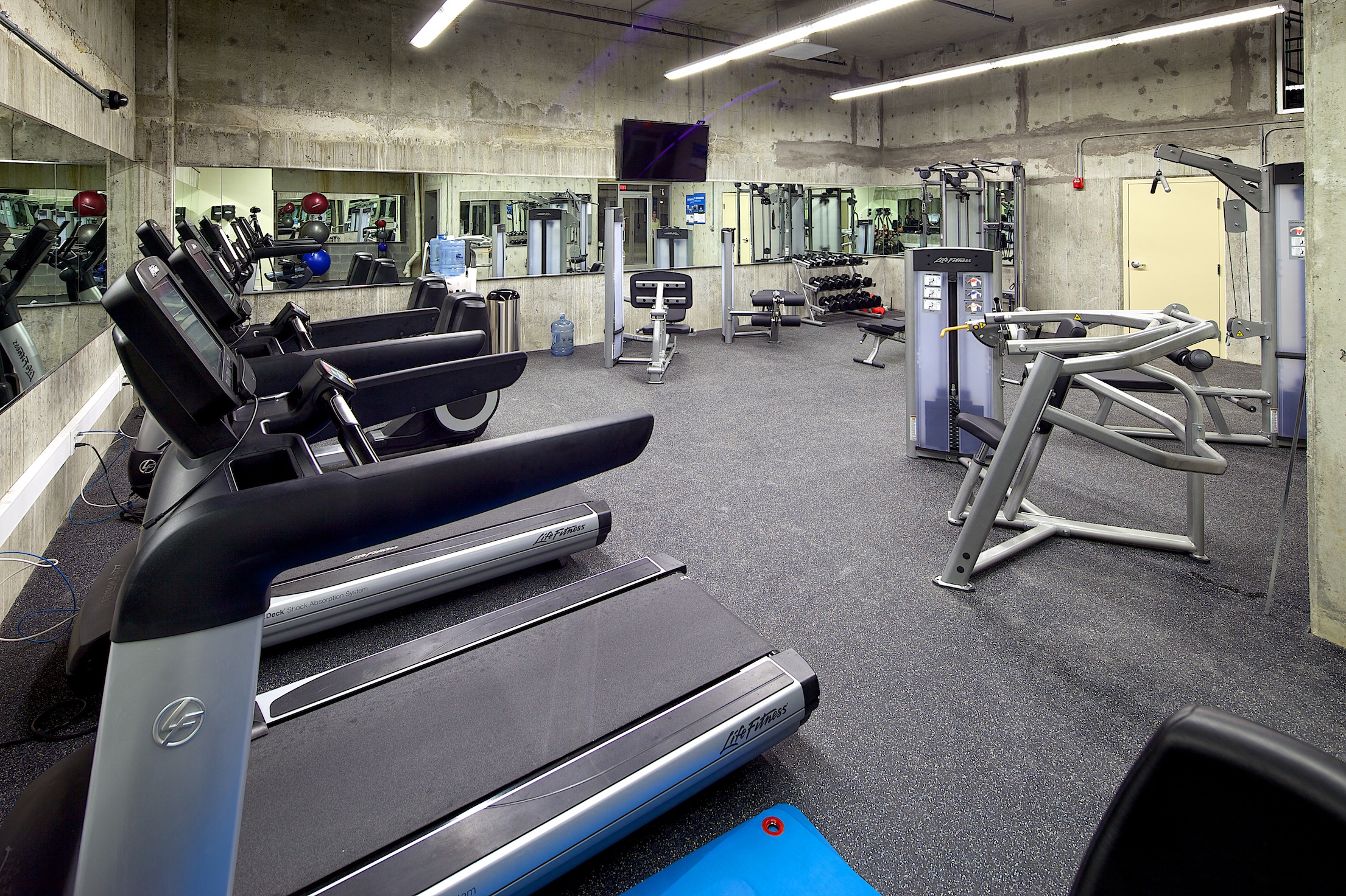 a gym with treadmills and other exercise equipment
