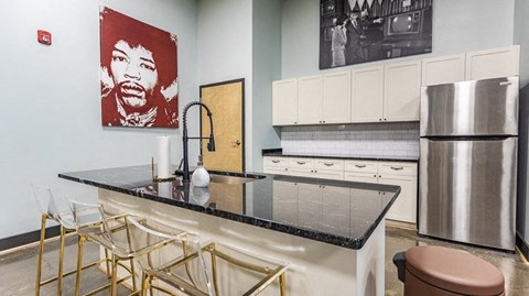 a kitchen with a counter top and a stainless steel refrigerator