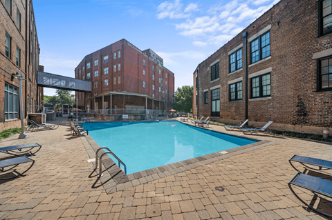 a swimming pool inbetween two brick buildings