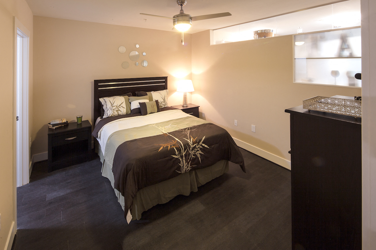 a bedroom with a bed and a ceiling fan