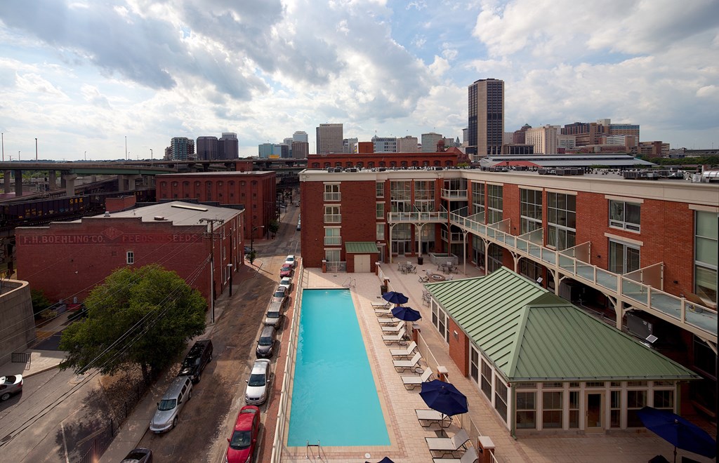 a hotel pool with a city in the background