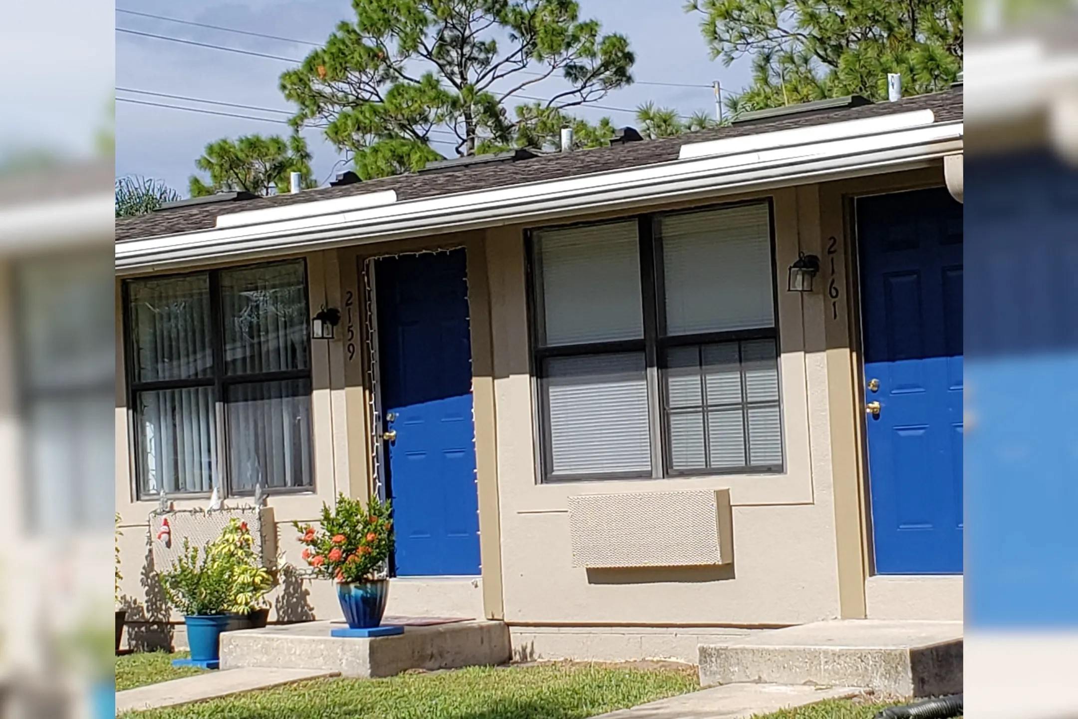 a house with two blue doors and a window