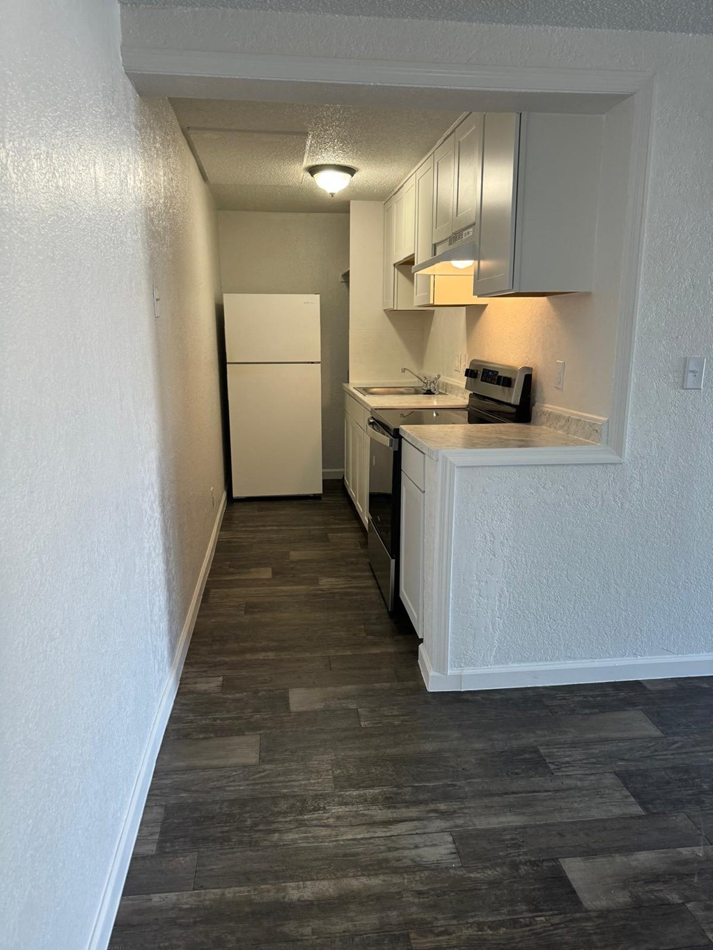 a kitchen with a white refrigerator and a counter top