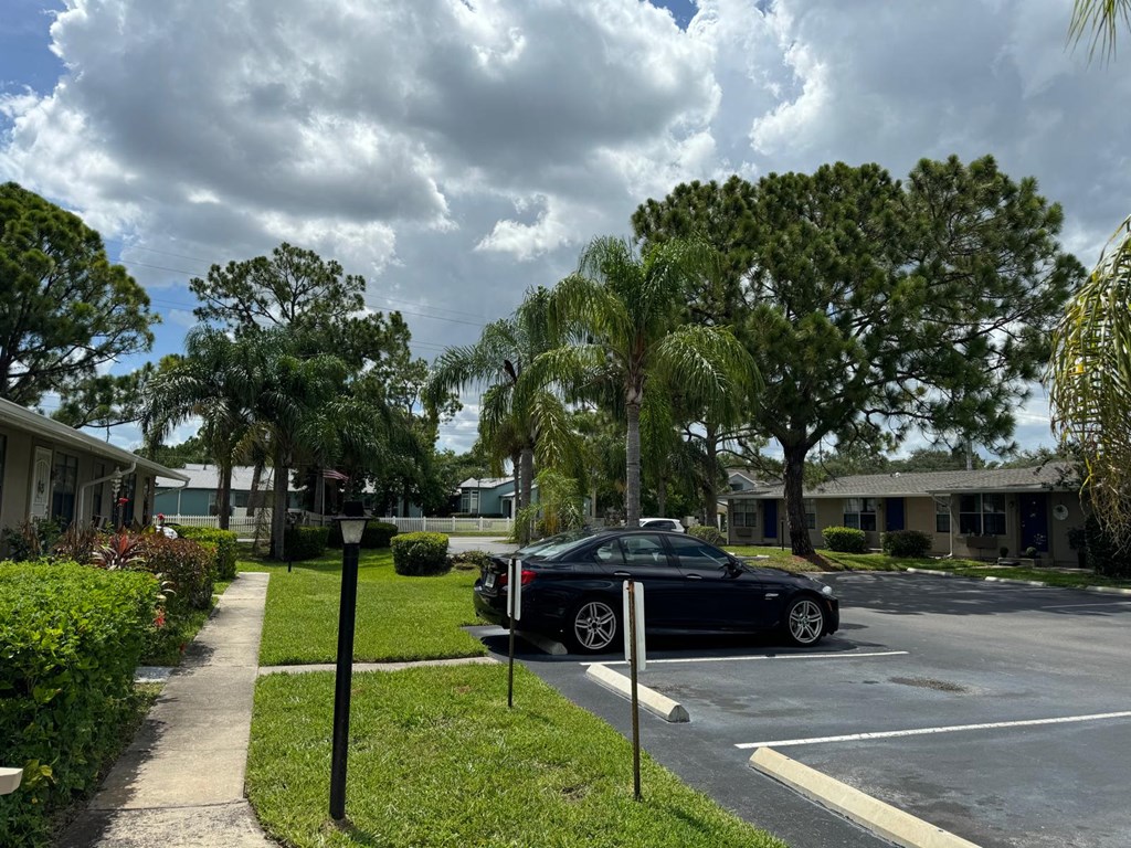 a car parked in a parking lot in front of a house
