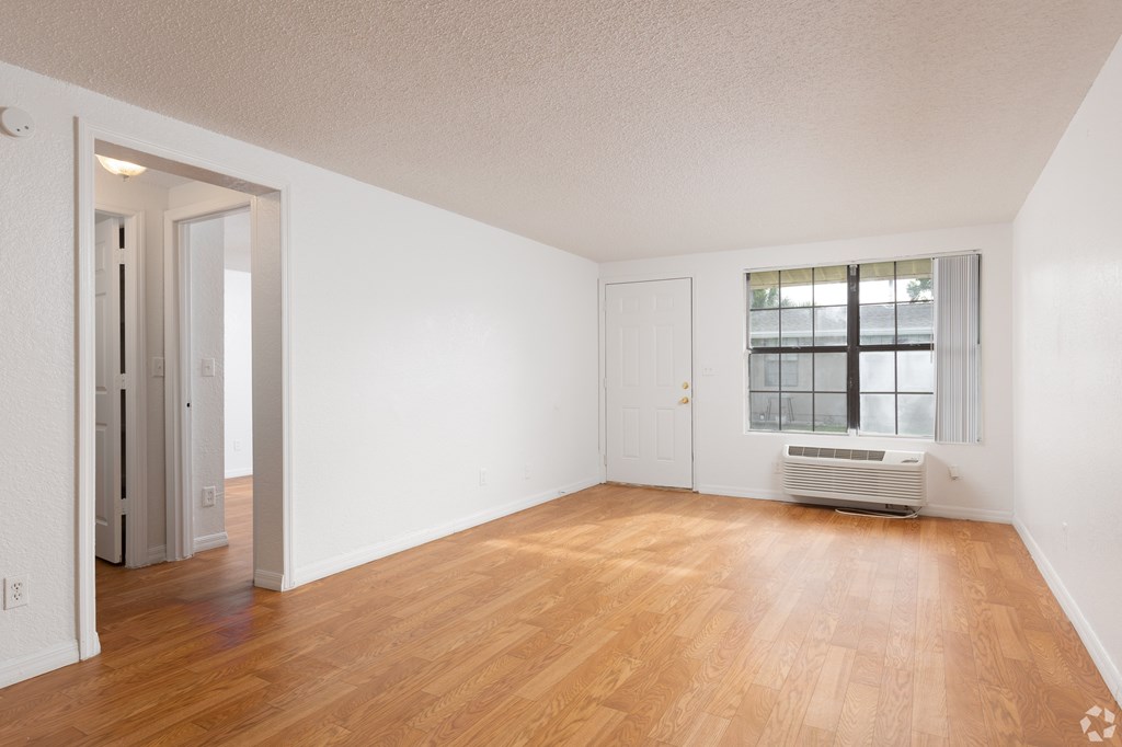 A room with wooden floors and white walls.