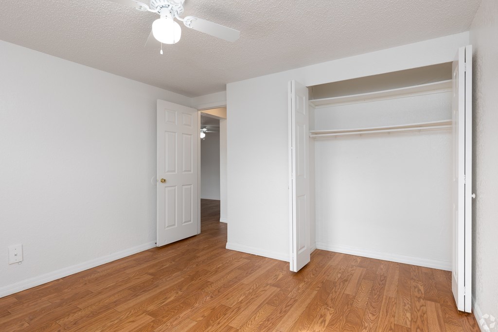 A room with a white door and a window.