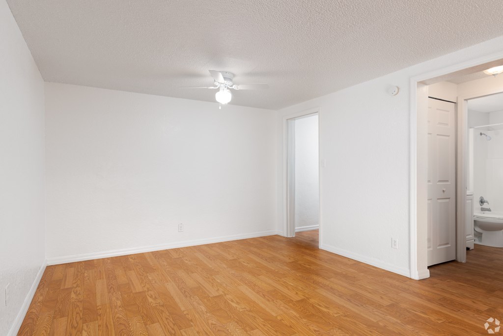 A room with wooden floors and white walls.