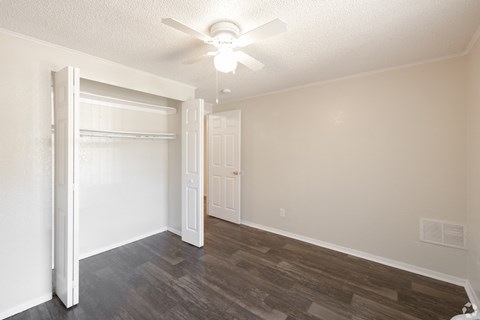 A room with a sliding door and a ceiling fan.