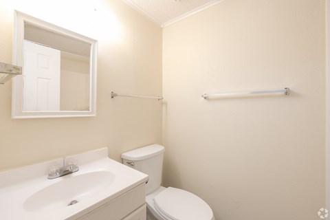 A white sink and toilet in a small bathroom.