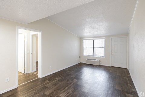 A room with wooden floors and white walls.