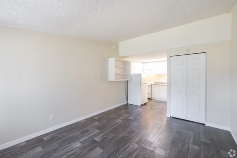 A room with a white door and a grey floor.
