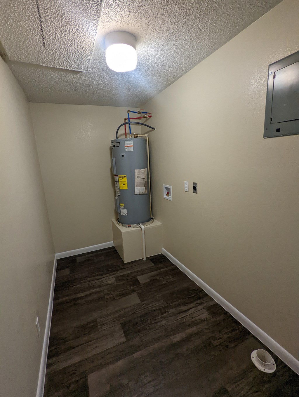 a room with a water heater in the corner