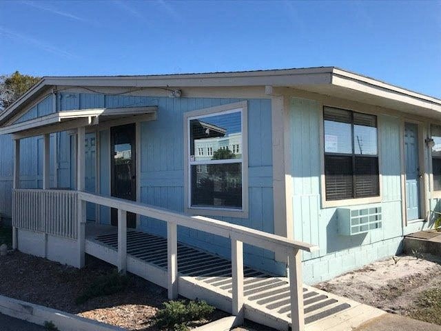 a blue house with a porch and a window