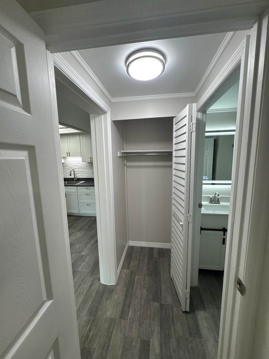 A white door is open to a bathroom.