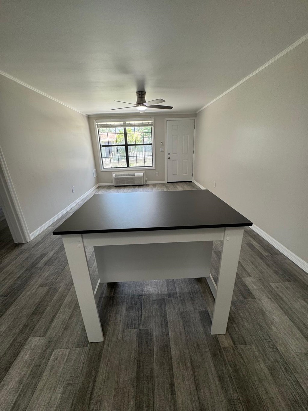 A room with a table and a window.