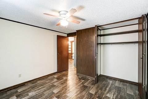 a bedroom with a closet and a ceiling fan