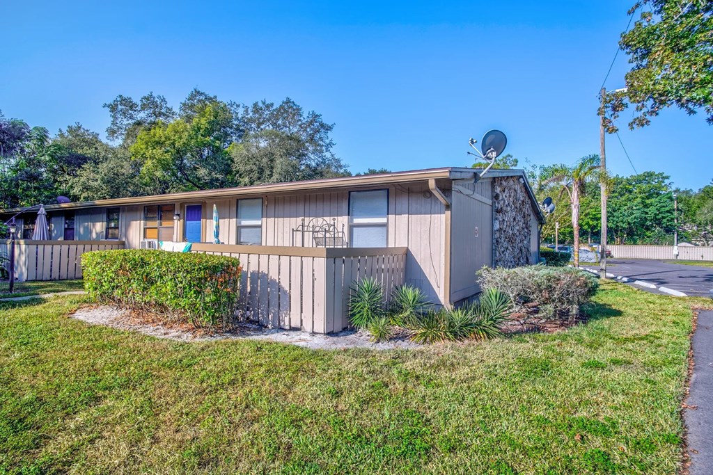 a house with a yard and a satellite dish on the roof
