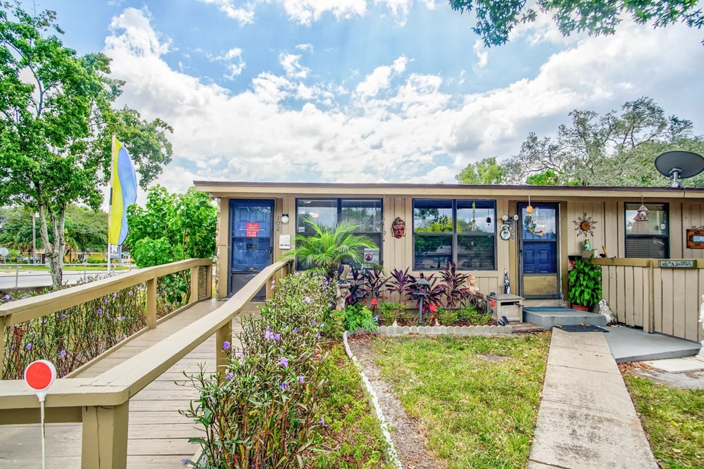 the front of a house with a porch and a walkway