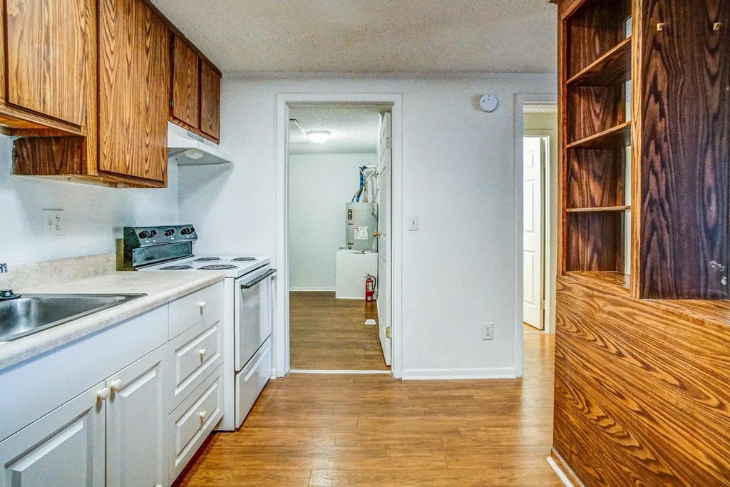 a kitchen with white appliances and wooden cabinets
