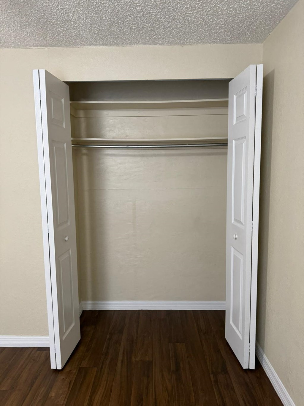 an empty room with a closet and a door