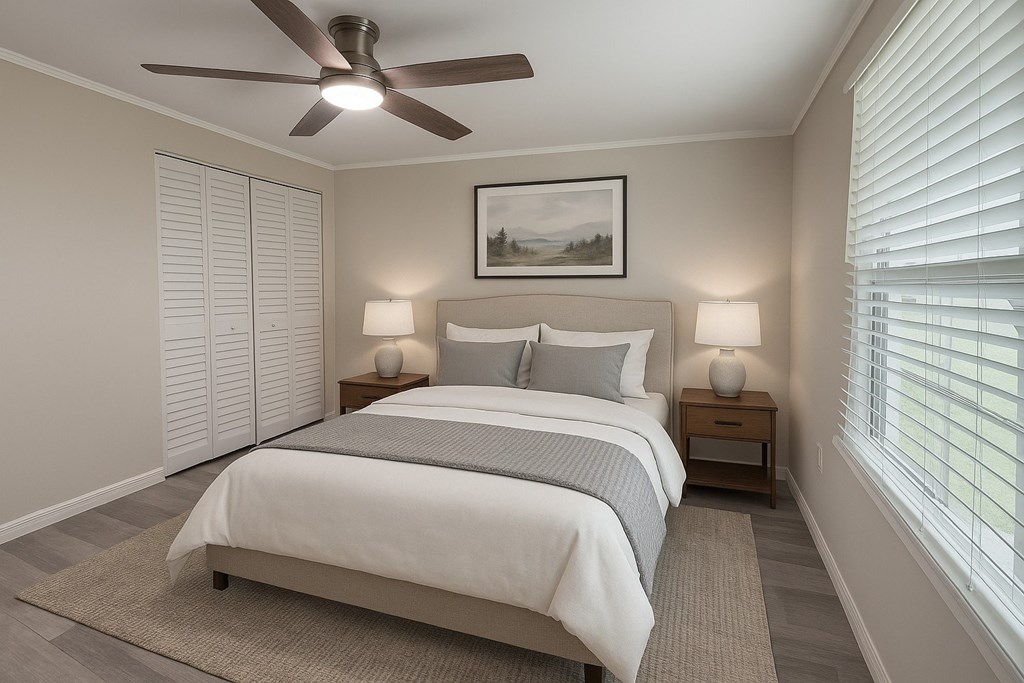 A bedroom with a bed, two lamps, and a painting on the wall.