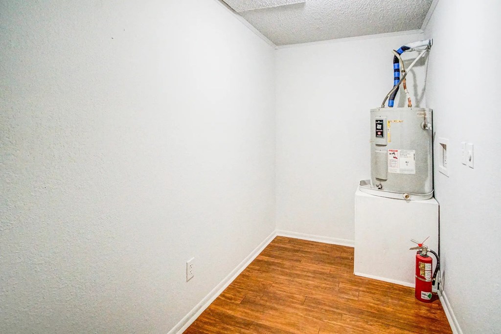 a room with a refrigerator and a hard wood floor