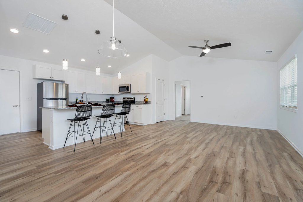 A kitchen with a bar area and a dining table.