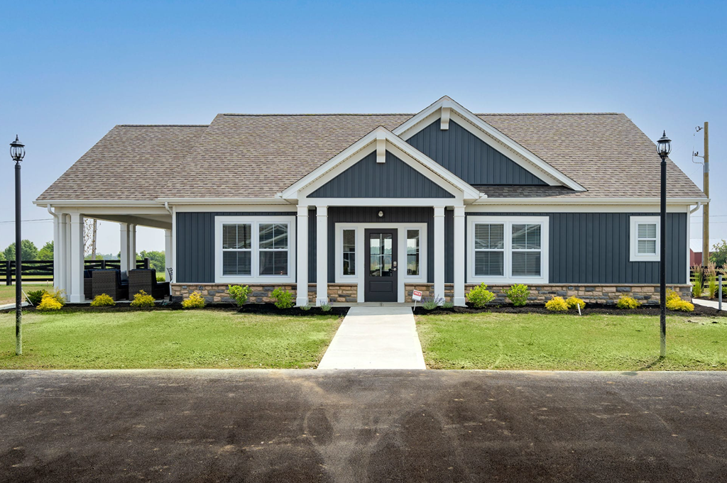 A house with a dark blue exterior and a white front door.