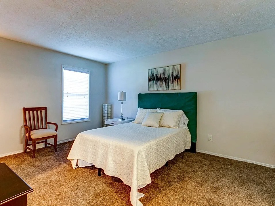 Bedroom with cozy bed and window at Birch Run, Georgia