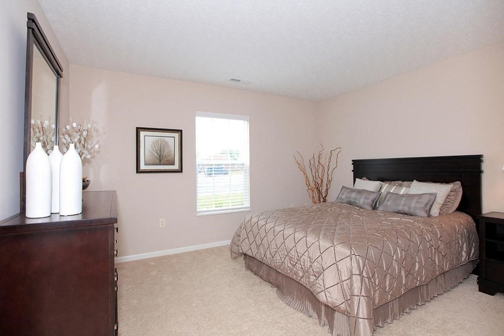 a bedroom with a bed and a dresser