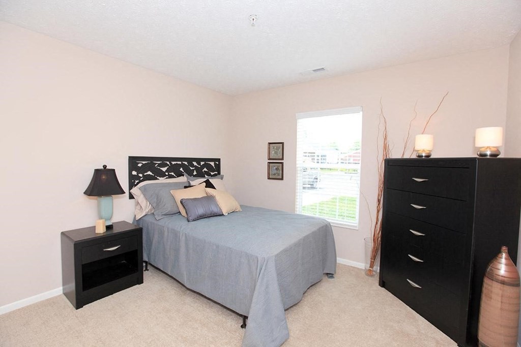 a bedroom with a bed and a dresser