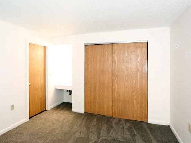 an empty room with a closet and a door