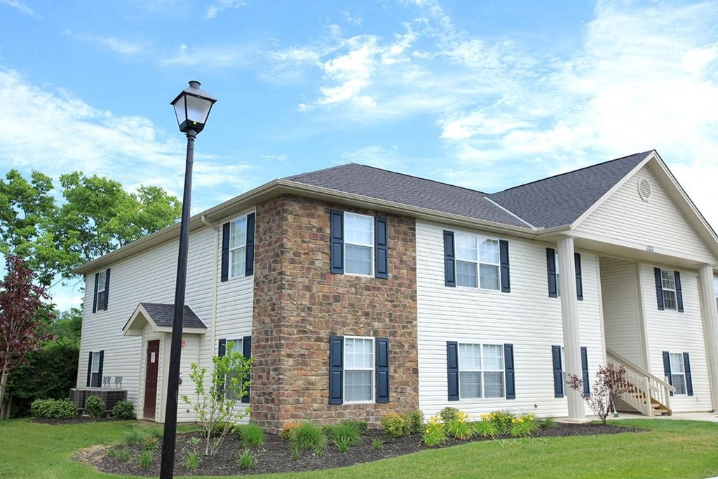 a white house with a lamp post in front of it