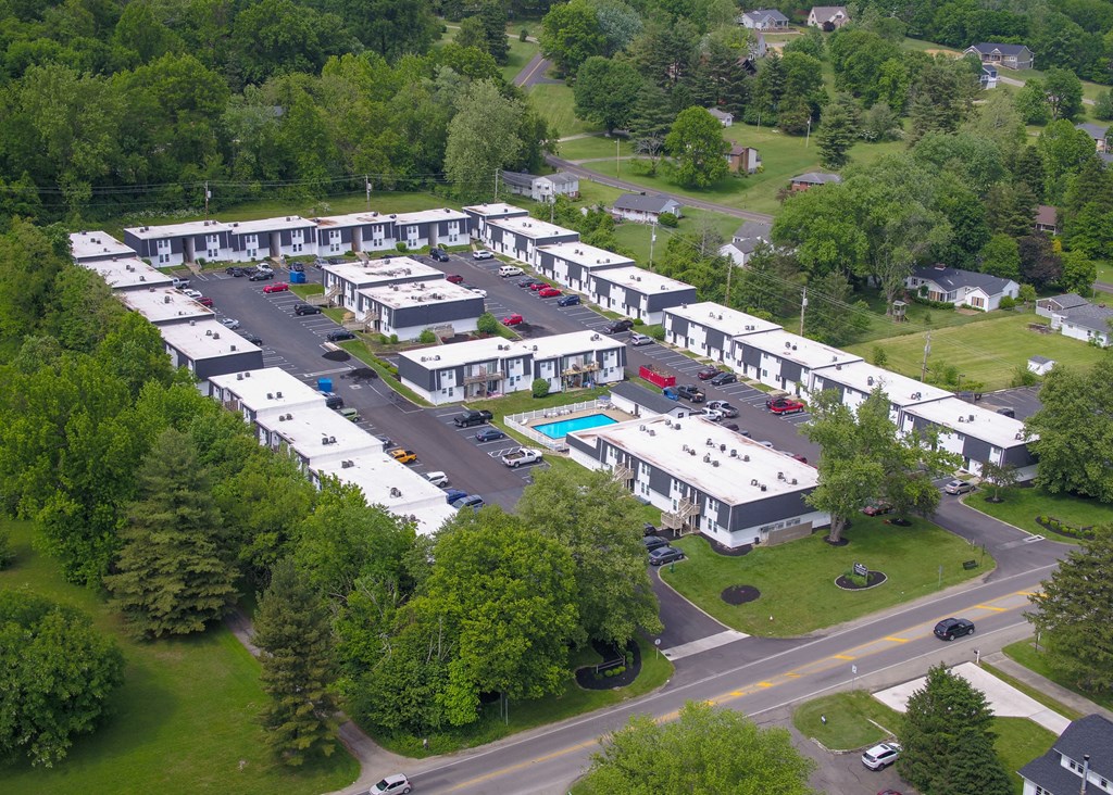 an aerial view of a group of white buildings and a swimming pool