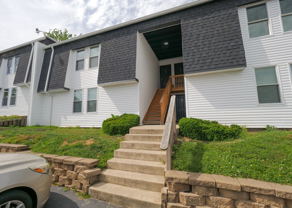 a white house with stairs in front of it