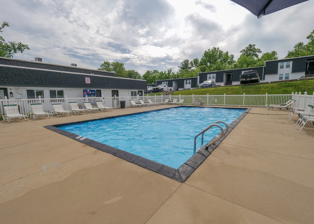 a swimming pool with chairs