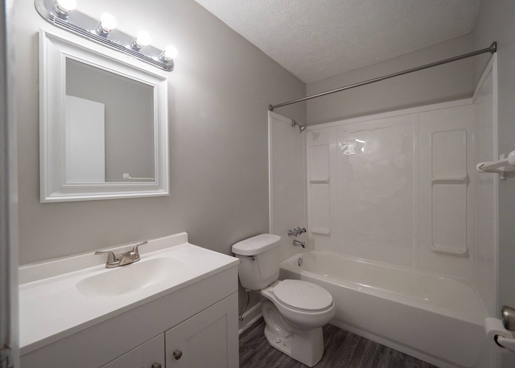 a bathroom with a sink toilet and a tub